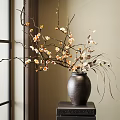 Elegant Dark Ceramic Vase With Plum Blossoms And Orchid Branches On Wooden Table
