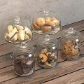Glass Jars and Cloches Holding Various Cookies Biscuits on Wooden Surface
