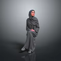 Woman in Gray Headscarf and Robe Sitting Against Gray Background with Hands Folded on Lap