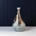 Metallic Teardrop Shaped Vase With Silver And Copper Mottled Texture On Black Background