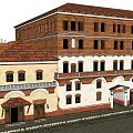 Traditional Red Brick Multi Story Building With Red Tile Roof Arched Windows And Wooden Accents