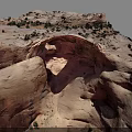 Natural Red Sandstone Rock Arch With Surrounding Desert Vegetation And Landscape