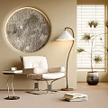 White Lounge Chair with Round Moon Decor Floor Lamp Side Table and Potted Plant