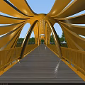 Yellow Arch Structure Bridge With Wooden Deck Railings Blue Sky And Trees