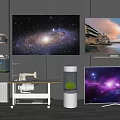 Multiple Modern Televisions Showcasing Galaxy And Landscape Scenes In Room With Table Plant And Fish Tank