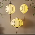 Three Beautiful Yellow Paper Lanterns Hanging With Bamboo Leaves For Interior Decoration
