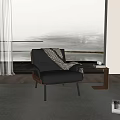 Black Leather Leisure Chair with Plaid Blanket and Side Table with Glasses Books by Window