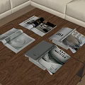 Open Magazines on Wooden Coffee Table with Pages Showing Images and Text