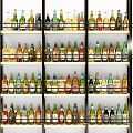 Organized Display Shelves With Various Bottles Arranged In Multiple Rows