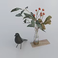 Transparent Vase with Red Berries Green and Dried Leaves on Wooden Tray with Black Bird Figurine