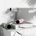 Modern Electric Hairdryers In White Pink Green On Marble Countertop With Plant Shadows