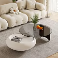 Modern Beige Sofa And Coffee Table Set With Curved Design Flower Cushions And Green Plants