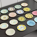 Assorted Colorful Dinnerware Set With Various Patterned Plates On Black Table