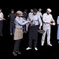 Group of Professional Chefs Preparing Food With Various Kitchen Utensils And Uniforms