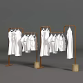 Art Installation With Brown Metal Frames Holding White Garments And Wooden Bases On Gray Background