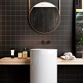 Washbasin with White Pedestal Wooden Countertop Black Tiled Wall Round Gold Frame Mirror and Towels