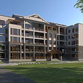 Modern Office Building Exterior With Large Glass Windows Stone Walls And Green Surrounding Lawn