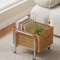 Wicker Side Table With Wheels Holding Books And Potted Plant Beside Sofa