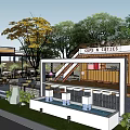 Shipping Container Cafe Building With Outdoor Seating Staircase Canopy And Green Plants