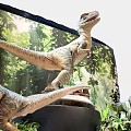 Realistic Reptile Dinosaur Models In Jungle Themed Display With Lush Green Plants