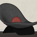 Modern Curved Gray Accent Chair With Red Sphere On Light Colored Wall And Wooden Floor