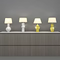 Four Modern White and Yellow Table Lamps with Fabric Shades on Grey Wooden Cabinet