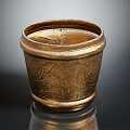 Ornate Golden Metallic Vessel Featuring Intricate Carved Patterns And Reflective Base