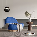 Blue Textured Accent Chair by Fireplace with Dried Plant Vase and Pendant Light