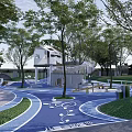 Fun Outdoor Children's Playground With Blue Ground White Patterns Green Trees And Play Structures