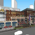 Vibrant Commercial Street With Modern Brick Buildings McDonald's Outdoor Seating Sunshades And Trees