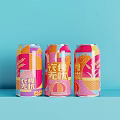 Three Vibrant Canned Drinks With Geometric Patterns On Light Blue Background