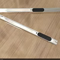 Stainless Steel Utility Knives With Serrated Blades And Black Handles On Wooden Table