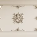 Ornate White Ceiling Carvings With Intricate Frame And Central Design