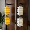 Yellow and White Hexagonal Lantern Wall Lamps on Dark Wooden Wall with Green Plant