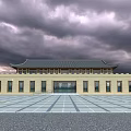 Ancient Architecture With Traditional Roof Yellow Walls And Spacious Square Under Cloudy Sky