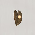 Modern Leaf Shaped Brown Wall Lamp With Round Bulb On Light Wall