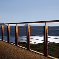 Modern Outdoor Railing With Wooden Posts And Metal Bars For Lakeside Scenic View