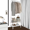 Modern Clothes Rack With Neutral Coats Basket Folded Clothes And VOGUE Poster