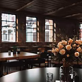 Rustic Bar Interior With Wooden Ceiling Brick Walls Large Windows And Orange Roses On Tables
