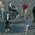 Diverse Group of People Standing and Sitting on Stone Pavement in Formal Attire
