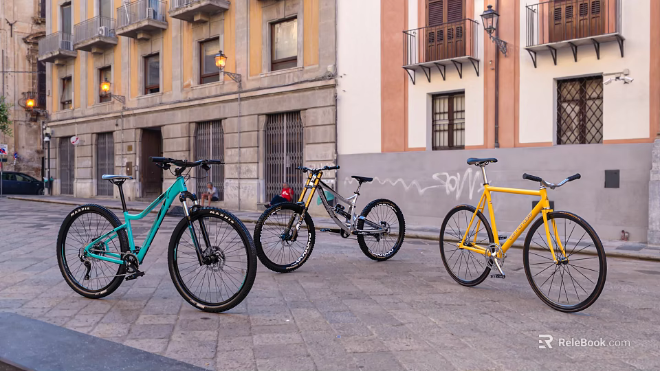 Three Colorful Bicycles Parked On Stone Paved Street With Graffiti Wall And Buildings 3d model 