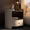 Elegant Modern Beige Leather Nightstand with Round Drawer Metal Handle Small Statue and Table Lamp