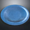 Blue Oval Plant Pot Featuring Lush Green Plant Against Dark Background