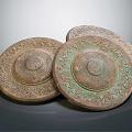 Ancient Three Circular Bronze Colored Artifacts With Intricate Carved Surface Patterns