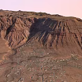Scenic Garden Landscape With Red Mountain Ranges And Small Town At Foot
