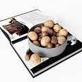 Bowl of Walnuts and Hazelnuts Placed on Open Book with Images and Text