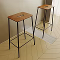 Modern Bar Stools With Brown Wooden Seat And Black Metal Frame On Light Wood Floor