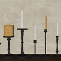 Modern Black Metal Candle Holders With Various Heights On Wooden Tabletop Against Gray Wall
