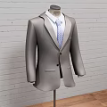 Three Classic Formal Suits On Mannequins With Brick Wall And Wooden Floor