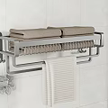 Wall Mounted Bathroom Metal Towel Rack With Brown Towels Beige Striped Towel And Bath Sponge